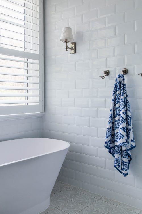 A Hamptons inspired bathroom with subway tiles and patterned floor.