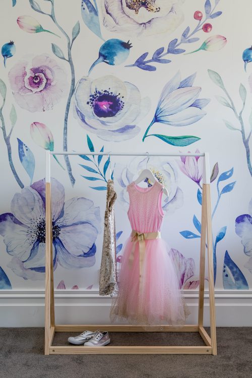 Bold floral wallpaper in a girl's bedroom.